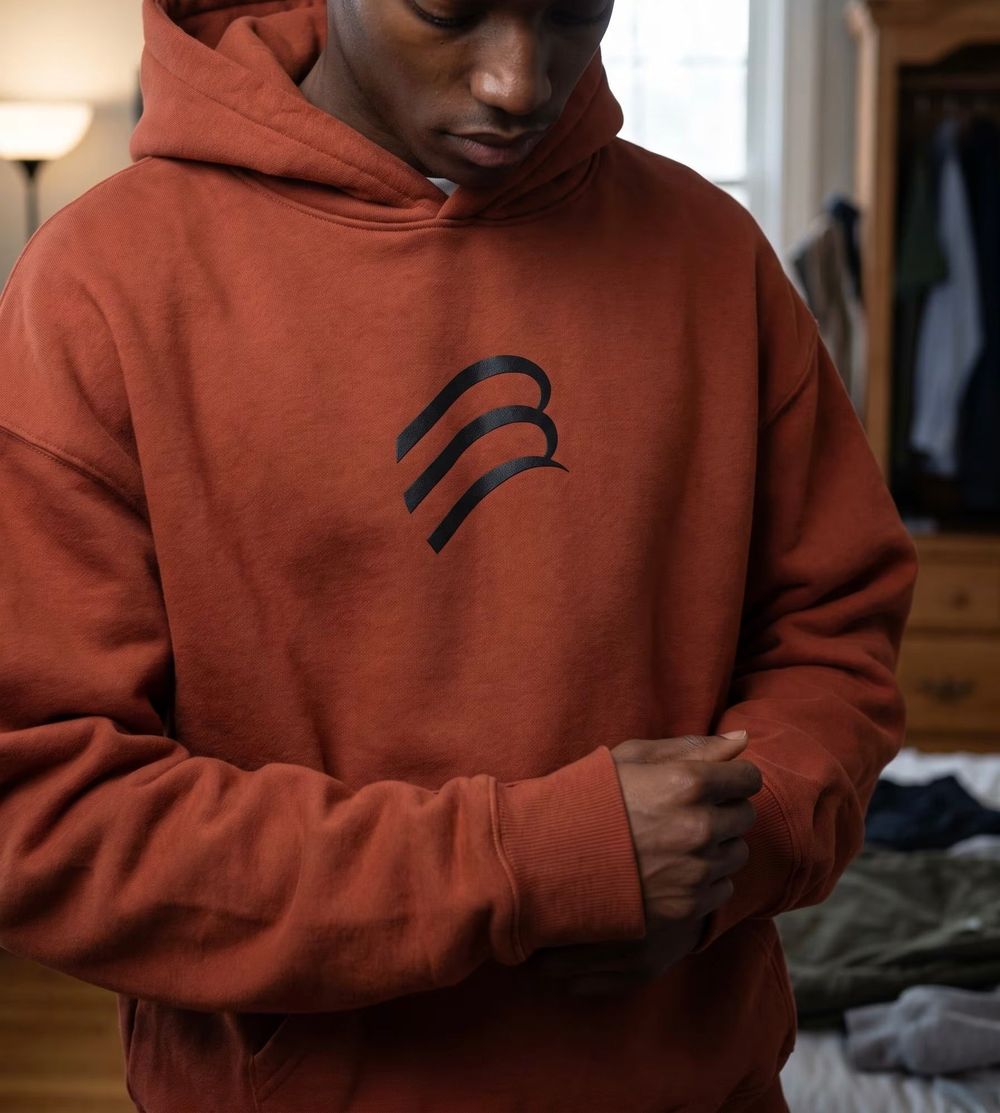 Rust-coloured heavyweight hoodie with a black printed Bespak mark on the chest
