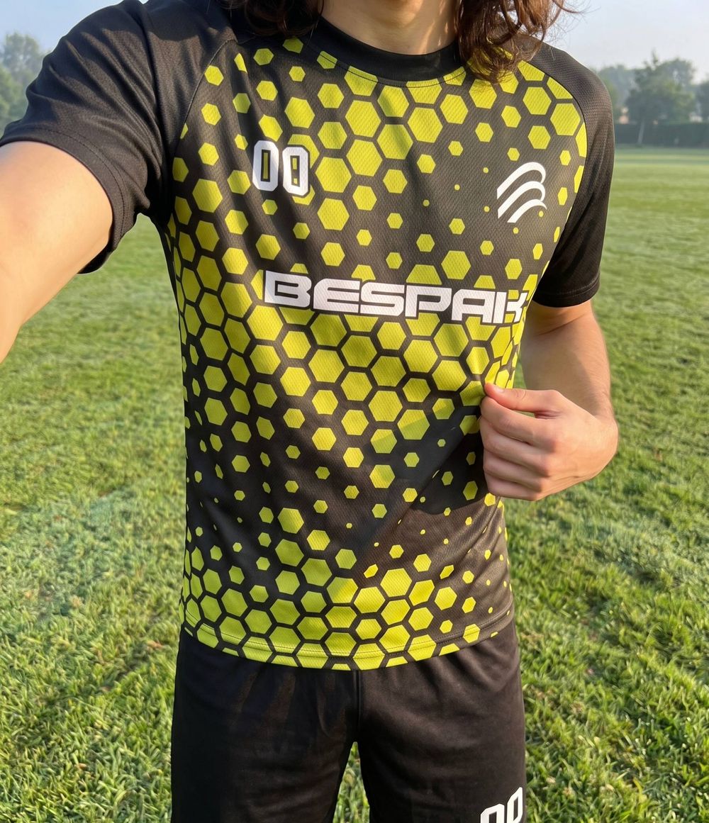 Black and yellow sublimated hexagon-pattern sports jersey with Bespak branding and a number